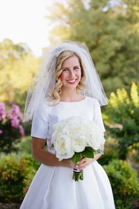 Bride with veil and white rose bouquet in gardens at LDS Temple, Sacramento, CA