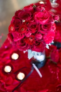 Closeup of red roses on couple table at wedding dinner